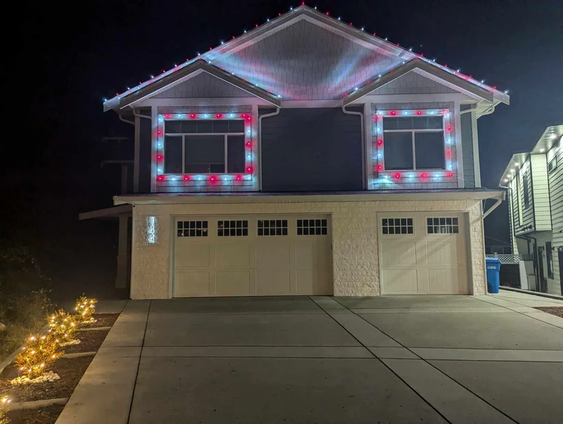 Professional Christmas light installation on a home's roofline and windows in Nanaimo BC.